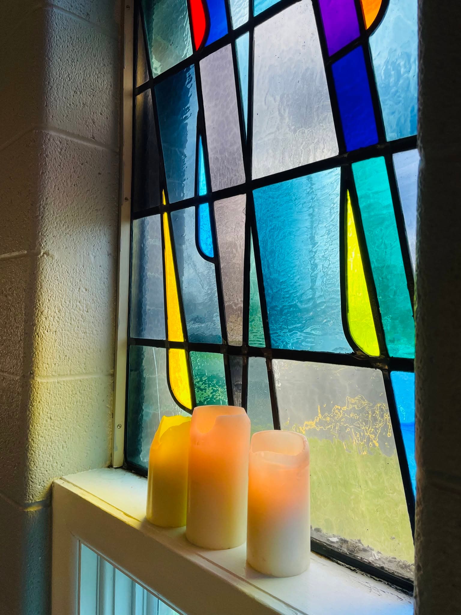 Candles by our stained glass windows